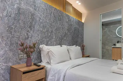 a bedroom with a large bed with white pillows at Stylish Living-Ioli in Athens