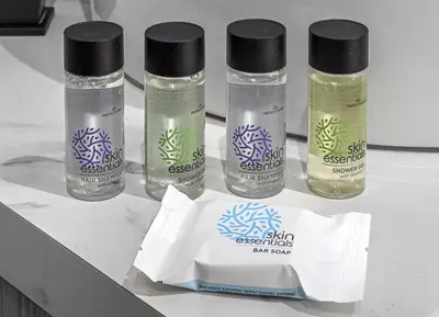 four bottles of essential oils sitting on a counter at Stylish Living-Ioli in Athens