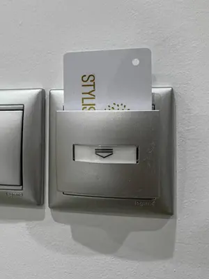 a lightswitch on a wall with a sign on it at Stylish Living-Ioli in Athens