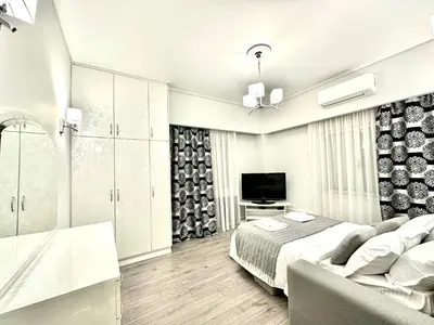 a bedroom with a bed and a flat screen tv at Modern home in Athens