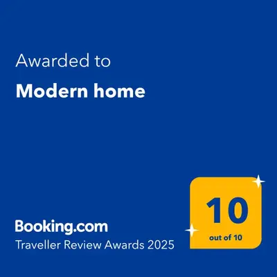 a yellow sign that reads awarded to modern home at Modern home in Athens