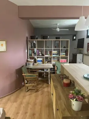 a living room with a table and a dining room at Διαμέρισμα στην Άνω Ηλιούπολη in Athens