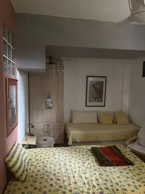 a living room with two beds and a couch at Διαμέρισμα στην Άνω Ηλιούπολη in Athens