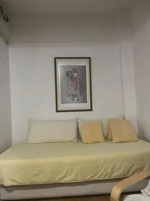 a bed in a room with a picture on the wall at Διαμέρισμα στην Άνω Ηλιούπολη in Athens