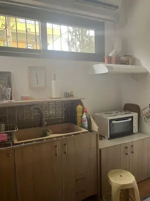a kitchen with a sink and a microwave at Διαμέρισμα στην Άνω Ηλιούπολη in Athens