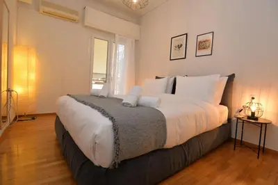 a bedroom with a large bed with white pillows at Zen Oasis Apartment in Athens