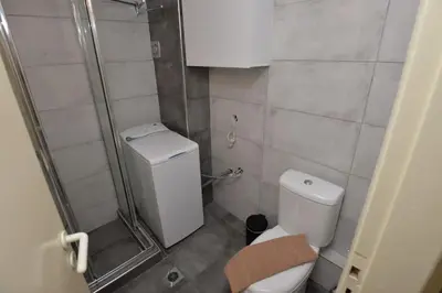 a small bathroom with a toilet and a shower at Zen Oasis Apartment in Athens