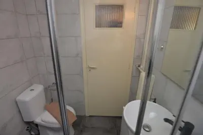 a small bathroom with a toilet and a sink at Zen Oasis Apartment in Athens