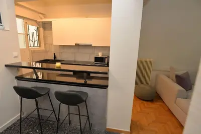 a kitchen with two stools and a counter top at Zen Oasis Apartment in Athens