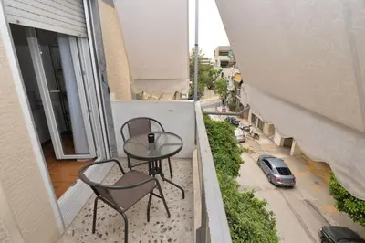 a balcony with a table and chairs and a street at Zen Oasis Apartment in Athens