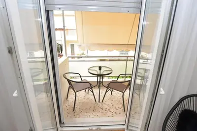 a room with a table and chairs in a kitchen at Zen Oasis Apartment in Athens