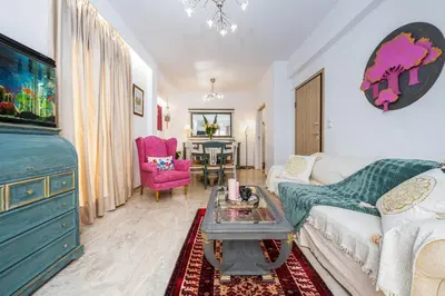 a living room with a couch and a table at Athenian Oasis Near Athens Metro Mall in Athens