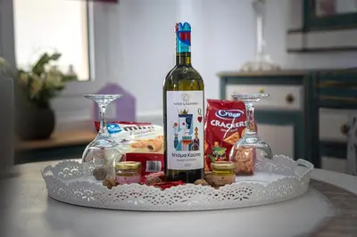 a bottle of wine sitting on a table with food at Athenian Oasis Near Athens Metro Mall in Athens