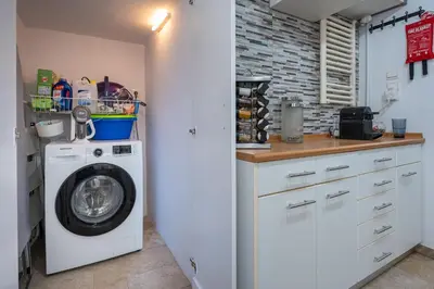 a kitchen with a washing machine in a kitchen at Athenian Oasis Near Athens Metro Mall in Athens