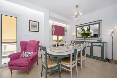 a dining room with a table and a purple chair at Athenian Oasis Near Athens Metro Mall in Athens