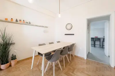 a dining room with a table and chairs at Spacious Urban Apt in the Heart of Athens in Athens