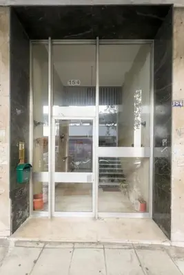 an entrance to a building with a glass door at Spacious Urban Apt in the Heart of Athens in Athens
