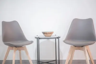 two chairs and a table with a bowl on it at Spacious Urban Apt in the Heart of Athens in Athens