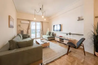 a living room with a couch and a table at Spacious Urban Apt in the Heart of Athens in Athens