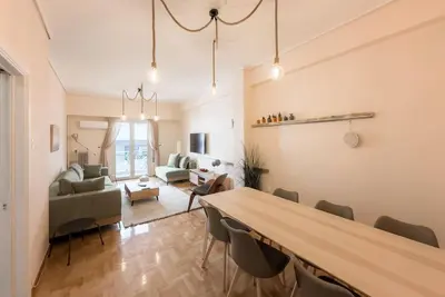 a living room with a large table and chairs at Spacious Urban Apt in the Heart of Athens in Athens