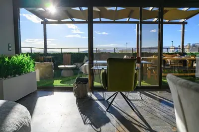 a patio with a table and a chair on a roof at Exclusive 2 bed Luxury Panorama in Athens