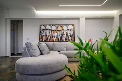 a living room with a gray couch and a painting at Exclusive 2 bed Luxury Panorama in Athens