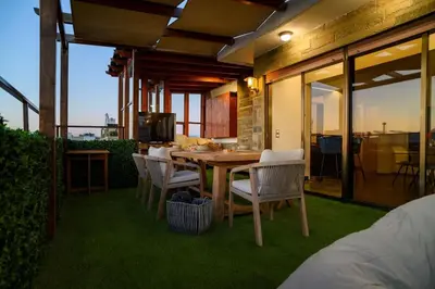 a patio with a table and chairs on the grass at Exclusive 2 bed Luxury Panorama in Athens