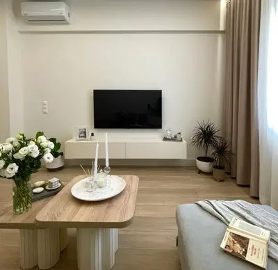 a living room with a table and a tv at Aurora apartment , in the Heart of Athens in Athens