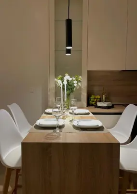 a table with wine glasses and flowers on it at Aurora apartment , in the Heart of Athens in Athens