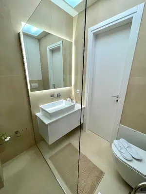 a bathroom with a sink and a toilet and a mirror at Aurora apartment , in the Heart of Athens in Athens
