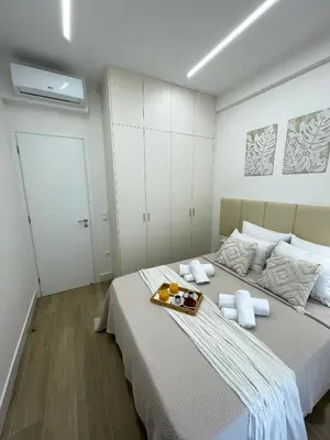 a bedroom with a bed with a tray of food on it at Aurora apartment , in the Heart of Athens in Athens
