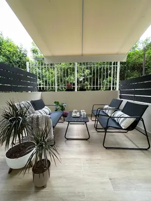 a patio with couches and a table and plants at Aurora apartment , in the Heart of Athens in Athens
