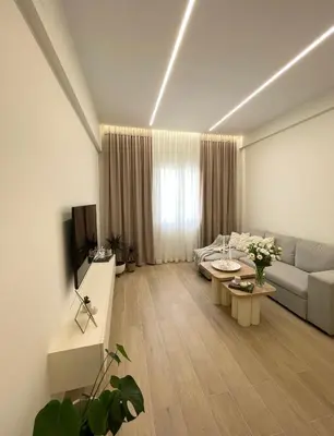 a living room with a couch and a table at Aurora apartment , in the Heart of Athens in Athens