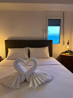 two swans making a heart on a bed at Sunny Modern Beach Retreat Steps from the Shore in Saronida