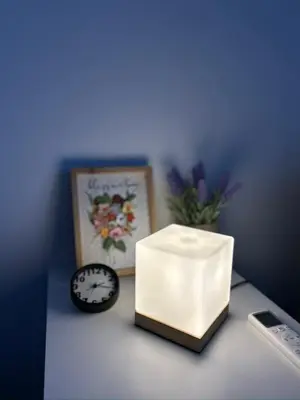 a clock and a box on a table with a clock at Sunny Modern Beach Retreat Steps from the Shore in Saronida