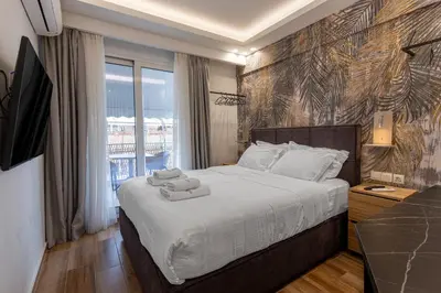 a bedroom with a large bed with towels on it at Stylish Living-Ariadne in Athens