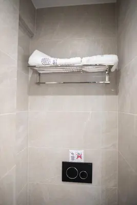 a bathroom with a shelf with two towels on it at Stylish Living-Ariadne in Athens