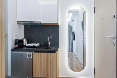 a kitchen with a sink and a mirror at Stylish Living-Ariadne in Athens