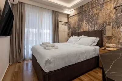 a bedroom with a large bed with towels on it at Stylish Living-Ariadne in Athens