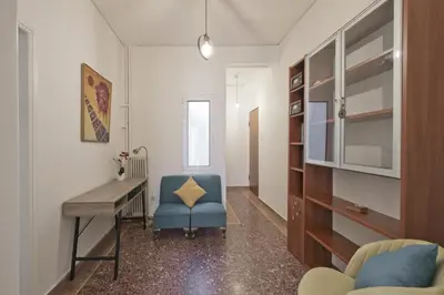 a living room with a desk and a blue chair at Alemar Quiet Kallithea Retreat with AC, Wifi in Athens