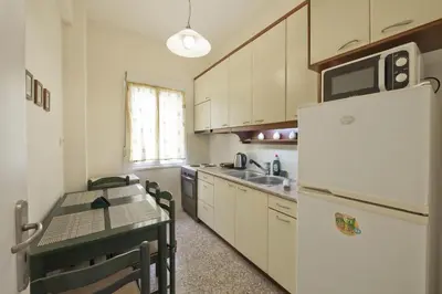 a kitchen with a table and a refrigerator at Alemar Quiet Kallithea Retreat with AC, Wifi in Athens