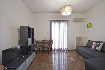 a living room with a couch and a table at Alemar Quiet Kallithea Retreat with AC, Wifi in Athens