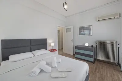 a bedroom with a large white bed with towels on it at Alemar Quiet Kallithea Retreat with AC, Wifi in Athens