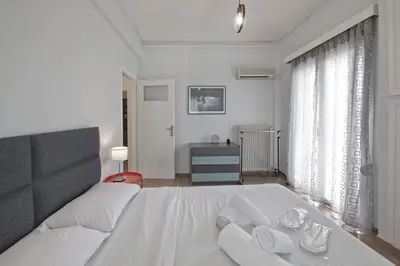 a bedroom with a white bed with towels on it at Alemar Quiet Kallithea Retreat with AC, Wifi in Athens