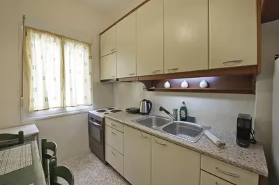 a small kitchen with a sink and a stove at Alemar Quiet Kallithea Retreat with AC, Wifi in Athens
