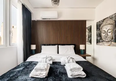 a bedroom with a bed with towels on it at Dema Luxury Suites - Perikleous E4 in Athens