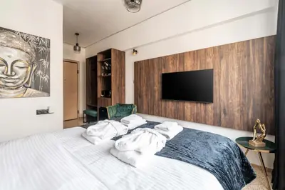 a bedroom with a bed with towels on it at Dema Luxury Suites - Perikleous E4 in Athens