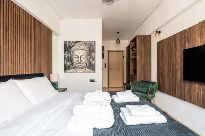 a bedroom with a bed with towels on it at Dema Luxury Suites - Perikleous E4 in Athens