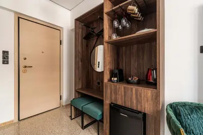 a room with a corridor with a door and a green stool at Dema Luxury Suites - Perikleous E4 in Athens