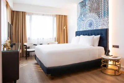 a hotel room with a large bed and a window at Luwian Athens Boutique Hotel in Athens